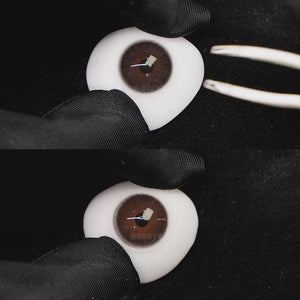 A simulated brown prosthetic eye showing the visual transformation effect of wearing diamond gray colored contact lenses against a black background.
