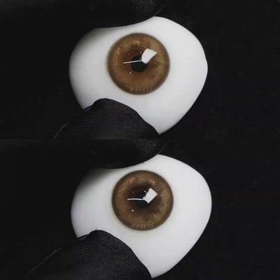A simulated brown prosthetic eye showing the visual transformation effect of wearing Wooeye Mulberry Brown colored contact lenses against a black background.