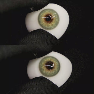 A simulated brown prosthetic eye showing the visual transformation effect of wearing Moonlit Green colored contact lenses against a black background.