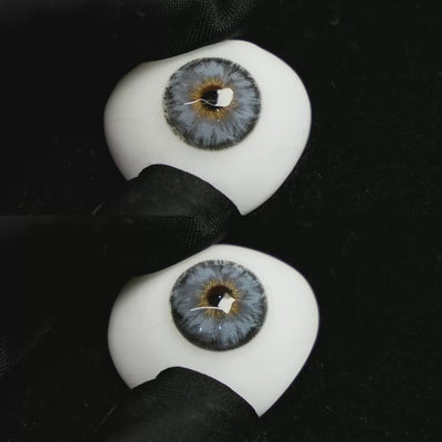 A simulated brown prosthetic eye showing the visual transformation effect of wearing Mermaid Blue colored contact lenses against a black background.