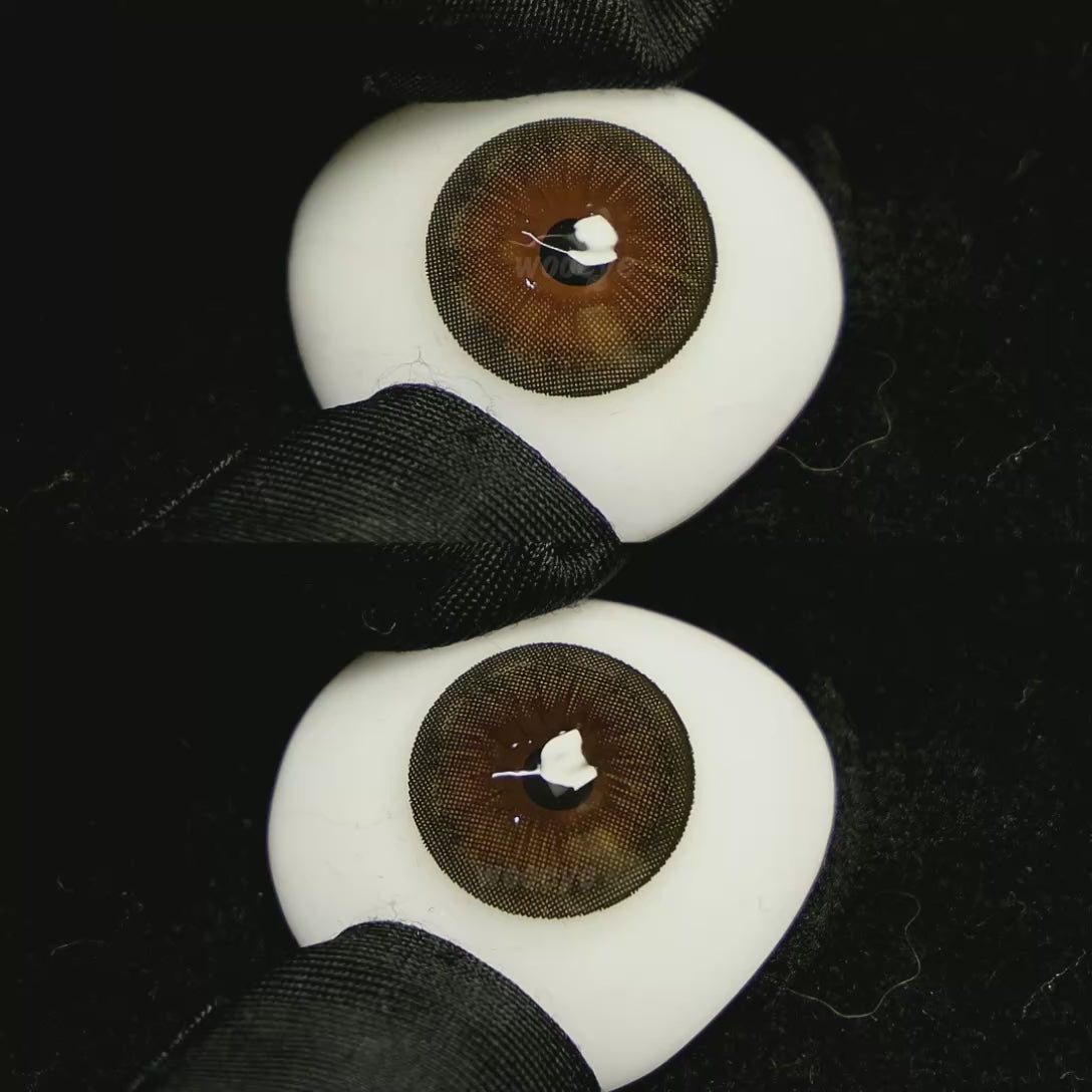 A simulated brown prosthetic eye showing the visual transformation effect of wearing Acorn Brown colored contact lenses against a black background.