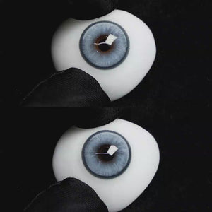 A simulated brown prosthetic eye showing the visual transformation effect of wearing Wooeye Boston Blue colored contact lenses against a black background.
