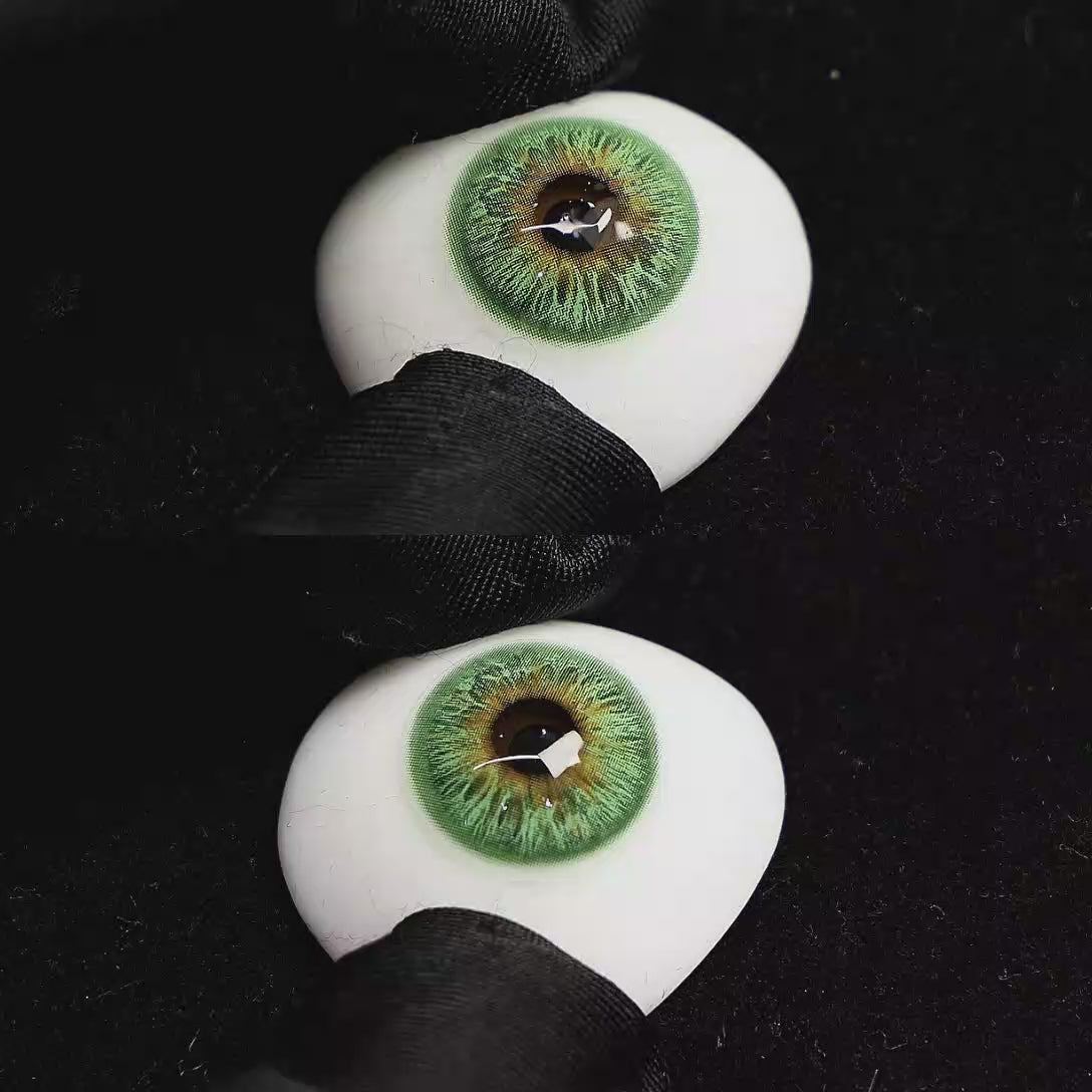 A simulated brown prosthetic eye showing the visual transformation effect of wearing Vegas Green colored contact lenses against a black background.