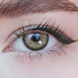 A simulated brown prosthetic eye showing the visual transformation effect of wearing alice brown colored contact lenses against a black background.