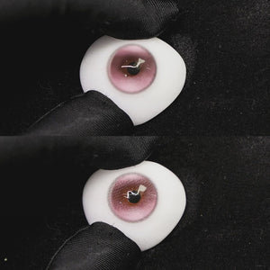 A simulated brown prosthetic eye showing the visual transformation effect of wearing halo pro pink colored contact lenses against a black background.